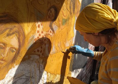 painting a fresco on yellow lime plaster
