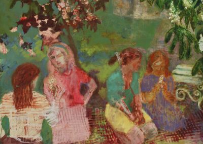 Four girls are sitting under a flowering chestnut tree