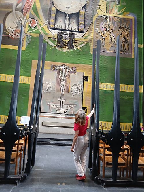 Olivia Irvine in front of Graham Sutherland Tapestry in Coventry Cathedral